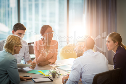 Group of business people discussing at desk