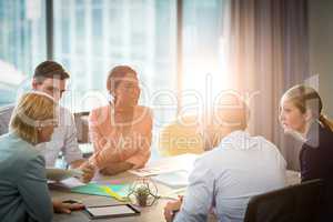 Group of business people discussing at desk