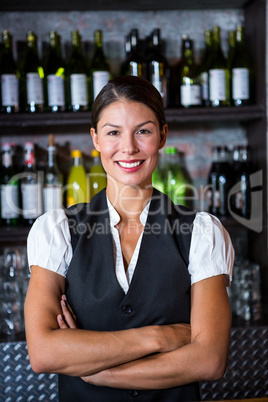 Smiling waitress with arms crossed