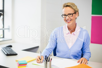 Teacher checking book in classroom