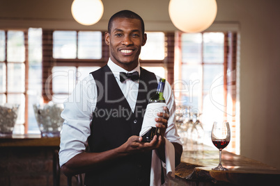 Portrait of bartender holding a wine bottle