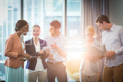 Group of business people interacting using mobile phone, digital