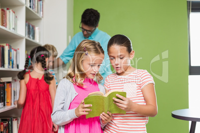 Kids reading book in library