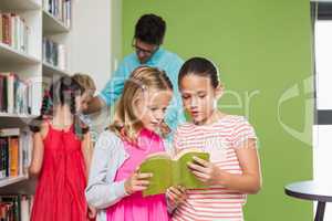 Kids reading book in library