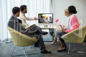 Business people looking at a screen during a video conference