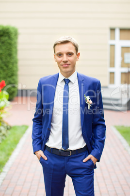 Blond bride in a blue suit