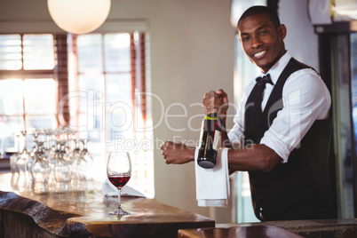 Portrait of bartender holding a wine bottle