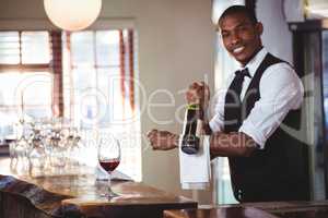 Portrait of bartender holding a wine bottle