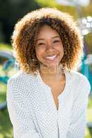 Happy woman sitting in park