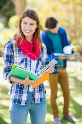 Portrait of college girl holding notes