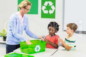 Teacher and kids discussing about recycle