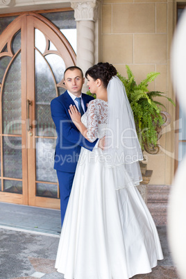 Couple standing in the rain on the wedding day