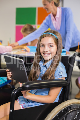 Disabled schoolgirl using digital tablet