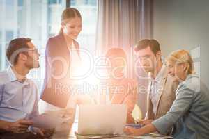 Group of business people interacting using laptop