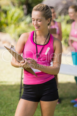 Female volunteer writing in clipboard