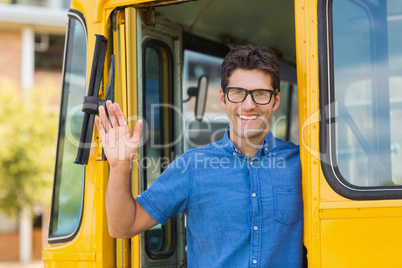 Portrait of teacher waving hand from bus