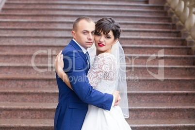 Couple standing in the rain on the wedding day