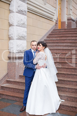 Couple standing in the rain on the wedding day