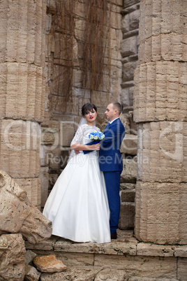 Couple standing in the rain on the wedding day