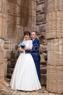 Couple standing in the rain on the wedding day