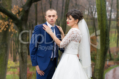 Couple standing in the rain on the wedding day