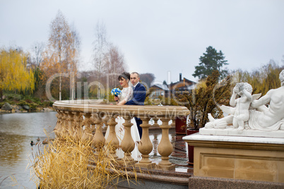 Couple standing in the rain on the wedding day