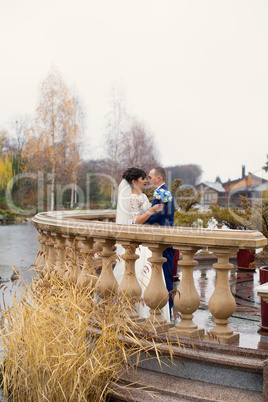 Couple standing in the rain on the wedding day