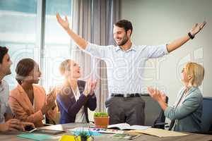 Coworkers applauding a colleague after presentation