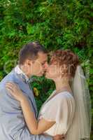 The groom kisses the bride tenderly