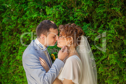 The groom kisses the bride tenderly