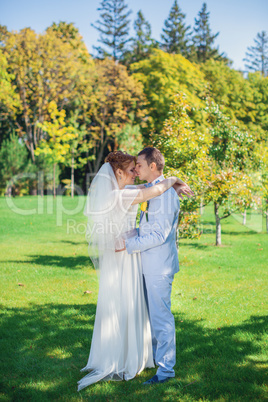 The groom gently embraces the bride