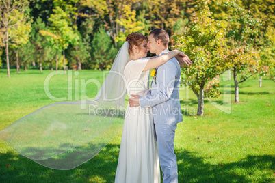 The groom gently embraces the bride