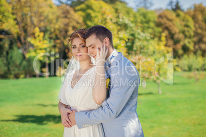 The groom gently embraces the bride