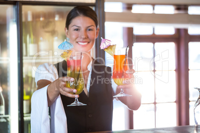 Waitress handing over cocktails