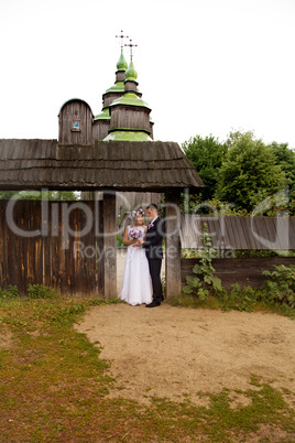 groom gently embraces the bride on walk in the country