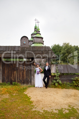 groom gently embraces the bride on walk in the country