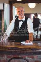 Portrait of bartender cleaning bar counter