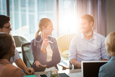 Group of business people interacting at desk