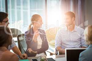 Group of business people interacting at desk