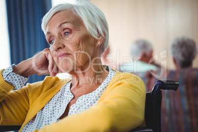 Senior woman in wheelchair look worried