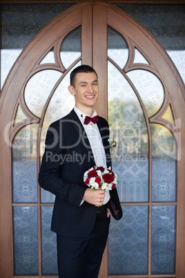 Portrait of the groom in a black suit