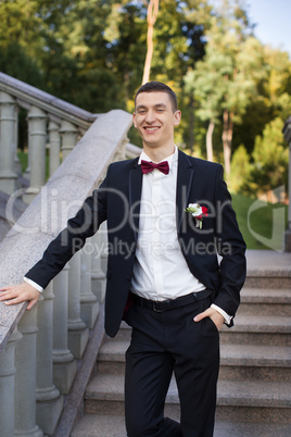 Portrait of the groom in a black suit