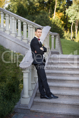 Portrait of the groom in a black suit