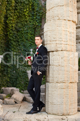 Portrait of the groom in a black suit