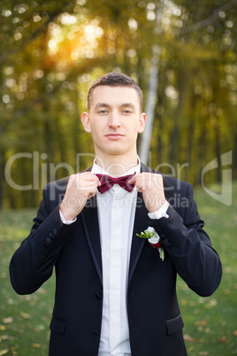 Portrait of the groom in a black suit