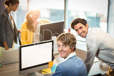 Men working on computer