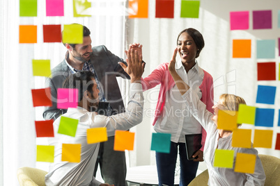 Business people giving high five