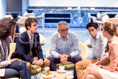 Business people having a discussion in cafeteria