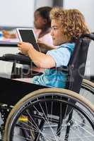 Disabled schoolboy using digital tablet