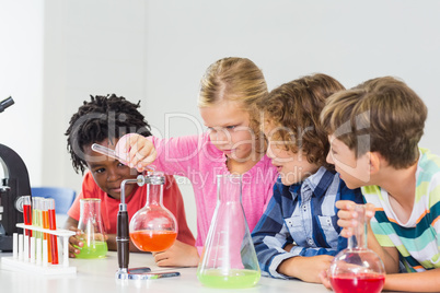 Kids doing a chemical experiment in laboratory